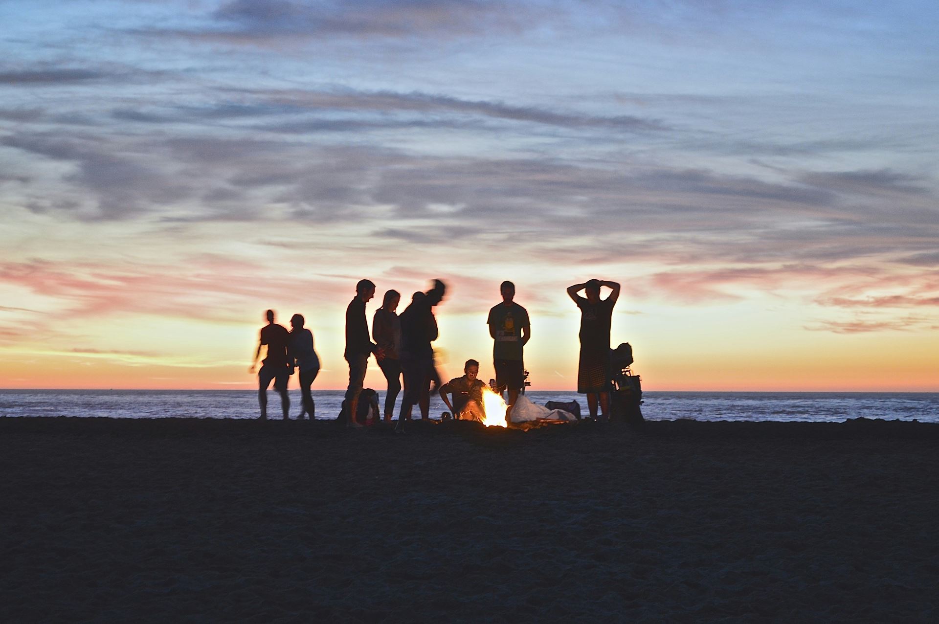 Group of people in front of a sunset